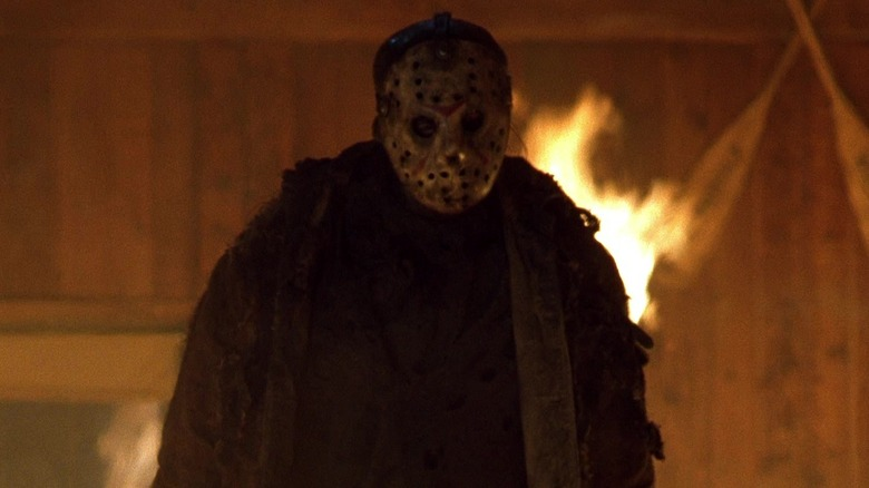 The Slasher (Jason Voorhees) walking forward through flames, an unstoppable force of horror - cinematic Dead by Daylight promo art